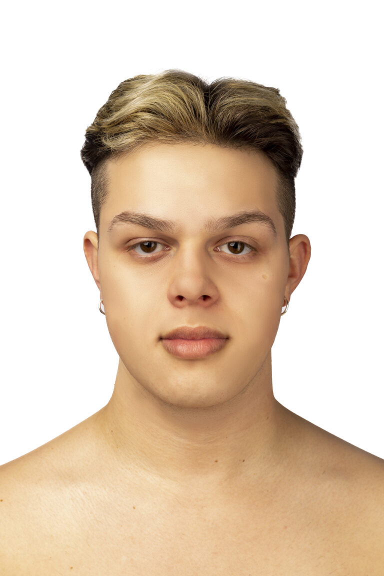 This is a close-up portrait of Alex topless in front of a white background