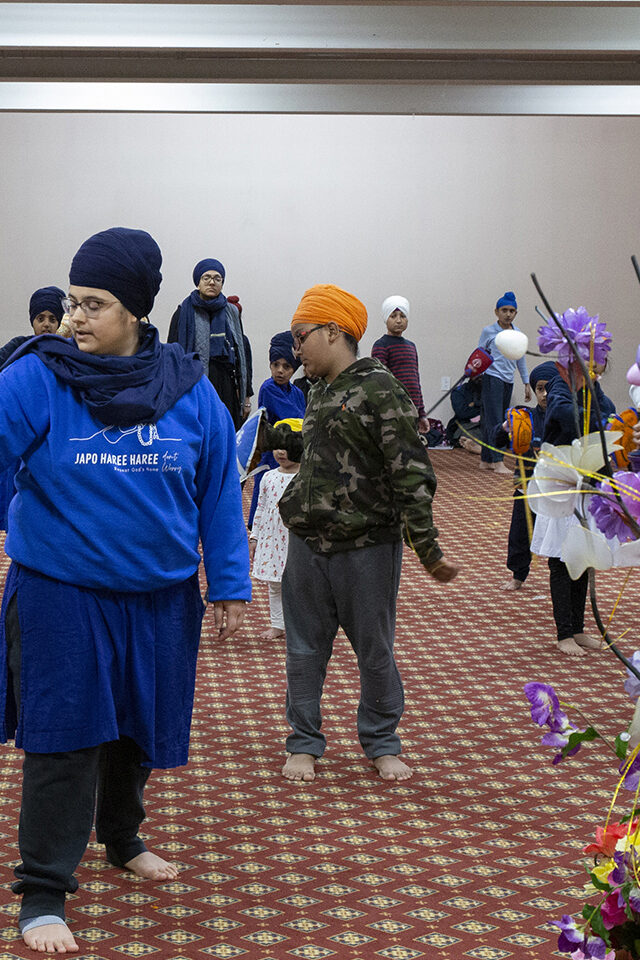 Woman teaching beginner students first Gatka fighting sequence