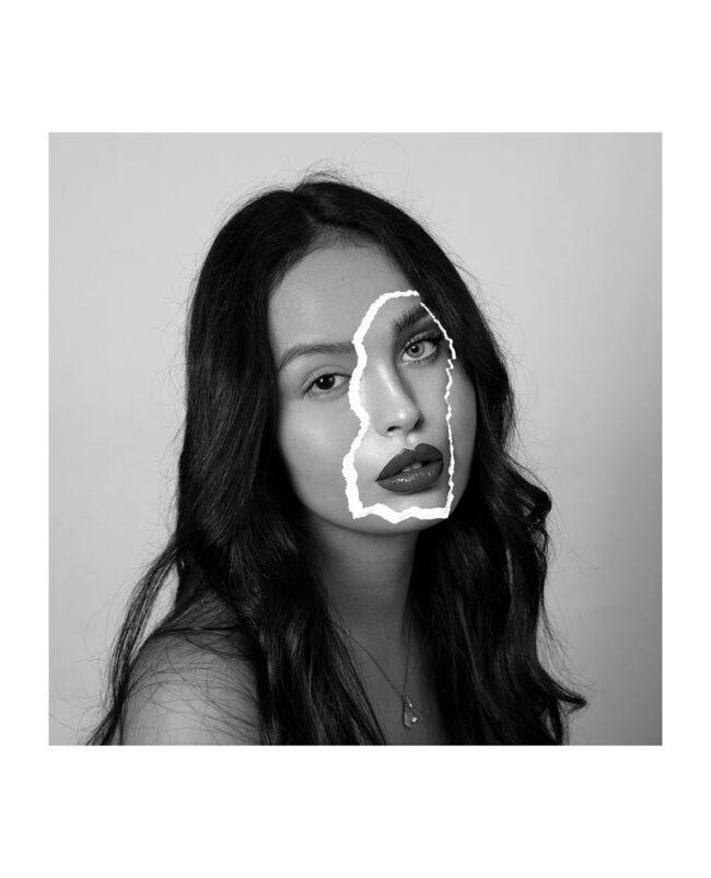 This photo is a portrait of a woman with no-makeup and black hair with a paper patch of another woman’s face on top of hers. This woman appears to be wearing make-up and is only shown as a torn piece of paper covering a part of the first woman’s face.
