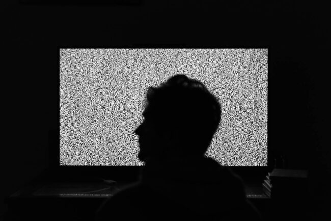 Man sits on his balcony and looks into a static void