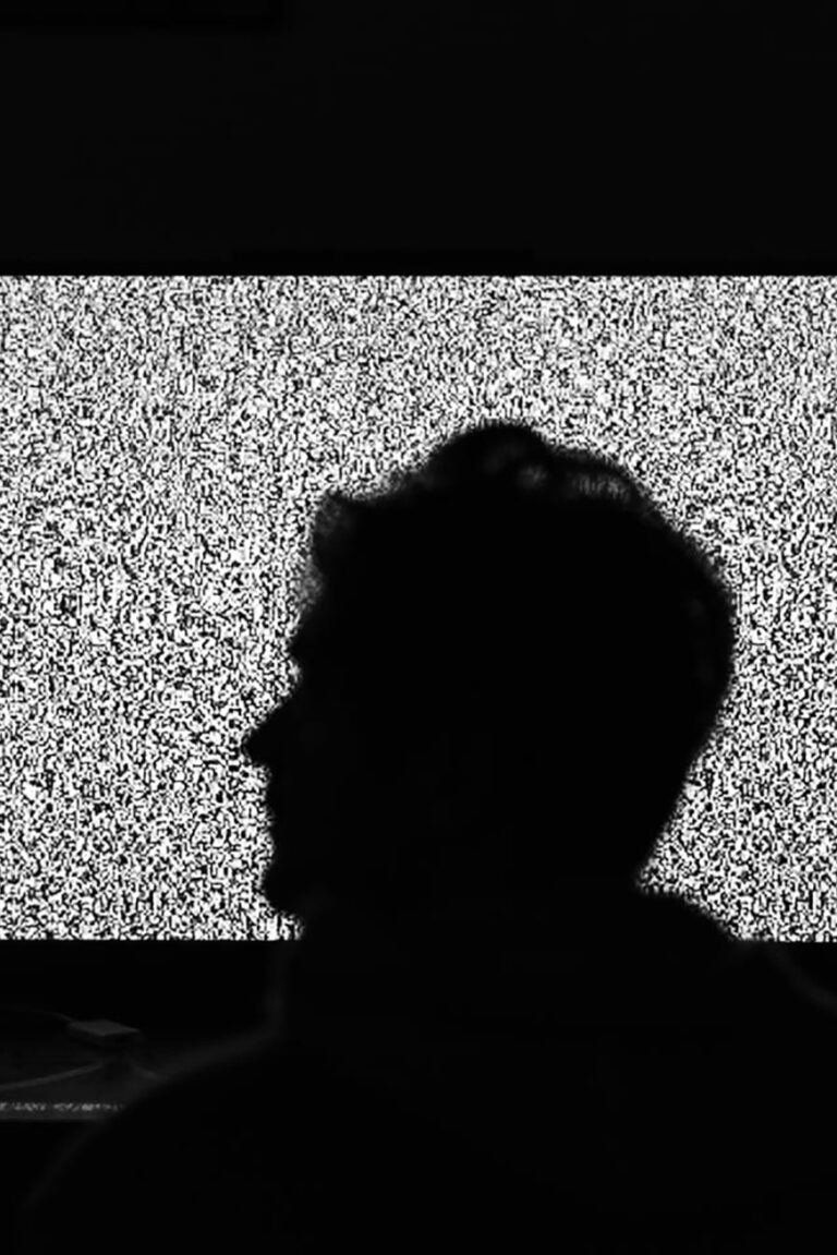 Man sits on his balcony and looks into a static void