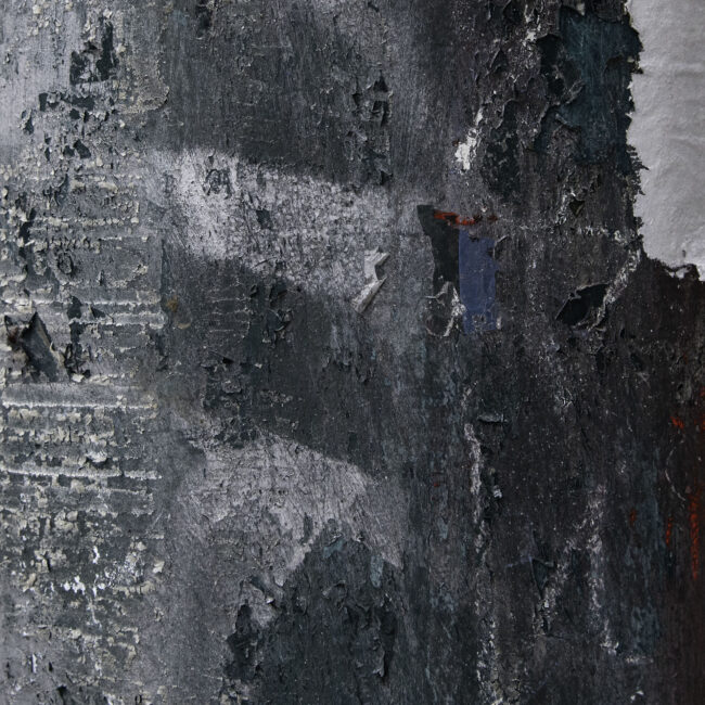 This is a zoomed in photo of a dark green telephone pole. On the right side of the photo there is a sticker on the pole that is plain white, it appears as if the sticker that was once there has been peeled off leaving the white adhesive part of the sticker. The pole appears to be peeling, there are red and white markings covering the pole. On the right side of the photo, the pole has horizontal straight lines going down it where the material the pole is made of is peeling which created alot of white patches.