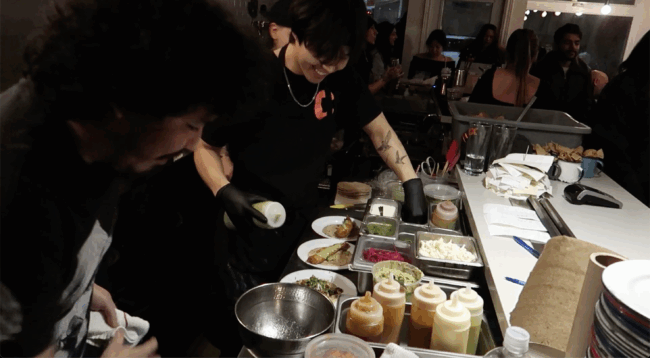 Back of house making food during a dinner rush.